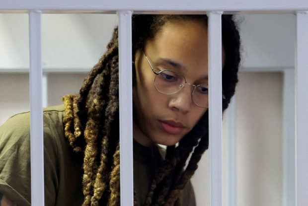 U.S. basketball player Brittney Griner, who was detained at Moscow's Sheremetyevo airport and later charged with illegal possession of cannabis, looks on inside a defendants' cage before a court hearing in Khimki outside Moscow, Russia August 2, 2022. REUTERS/Evgenia