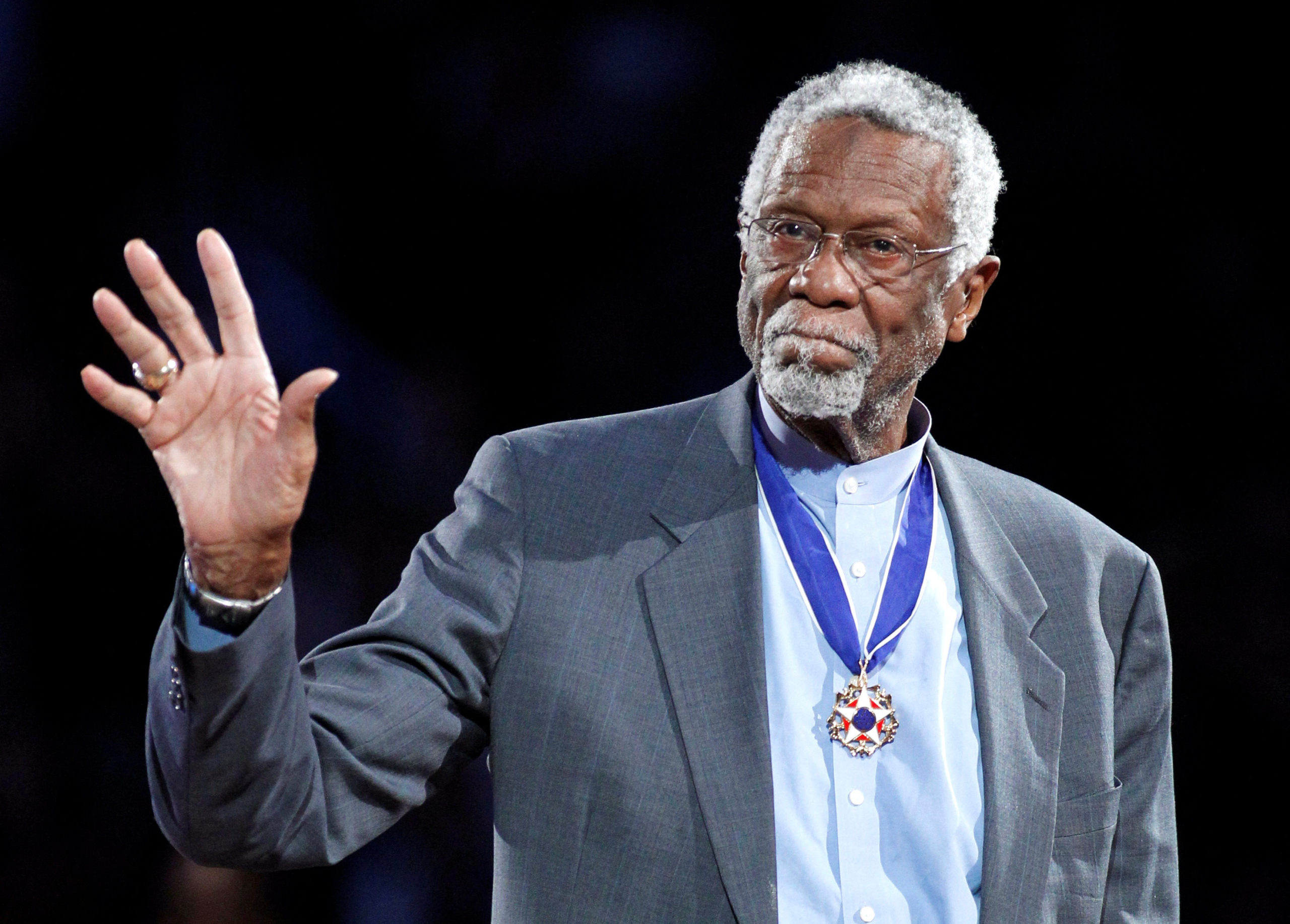 Boston Celtics' legend Bill Russell stands with his Presidential Medal of Freedom during the NBA All-Star basketball game in Los Angeles, February 20, 2011. REUTERS/Danny Moloshok/File Photo