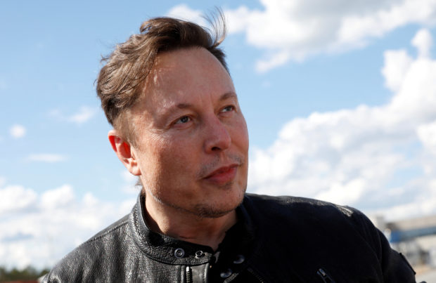 FILE PHOTO: Tesla CEO Elon Musk looks on as he visits the construction site of Tesla's gigafactory in Gruenheide, near Berlin, Germany, May 17, 2021. REUTERS/Michele Tantussi/
