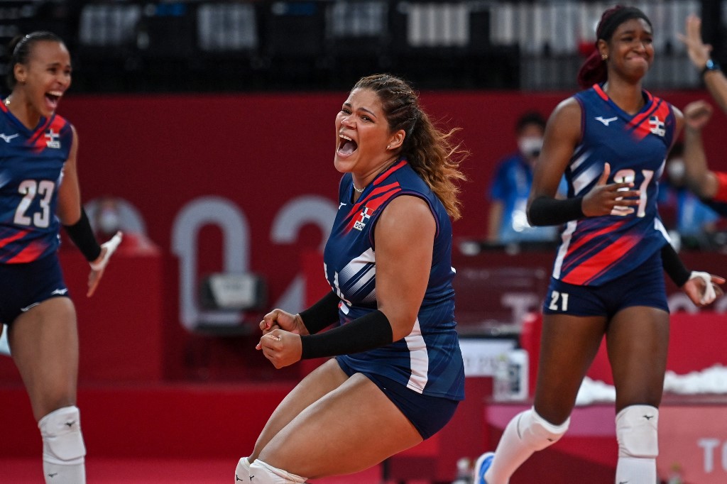 Dominican Republic's Prisilla Rivera Brens (C) celebrate their victory in the women's preliminary round pool A volleyball match between Japan and Dominican Republic during the Tokyo 2020 Olympic Games at Ariake Arena in Tokyo on August 2, 2021. 