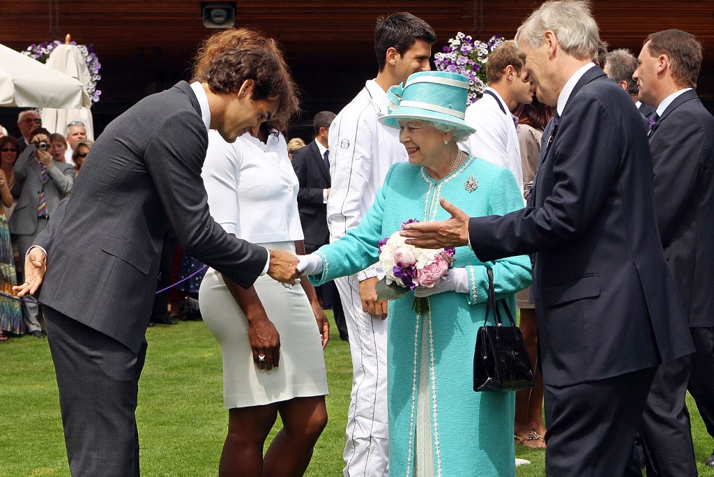 Swiss tennis player Roger Federer (L) bows as he meets Britain's Queen Elizabeth II (4th L) during a visit to the 2010 Wimbledon Lawn Tennis Championships in south-west London, on June 24, 2010.  
