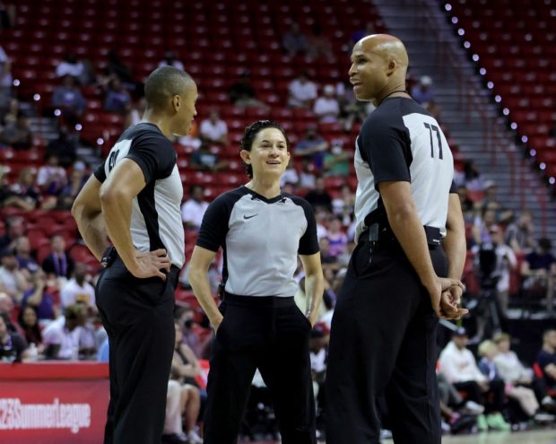 Referees Robert Hussy and Cheryl Flores and ESPN sports analyst and former NBA player Richard Jefferson talk on the court as Jefferson joins them to officiate the second quarter of a game between the New York Knicks and the Portland Trail Blazers during the 2022 NBA Summer League at the Thomas & Mack Center on July 11, 2022 in Las Vegas, Nevada.