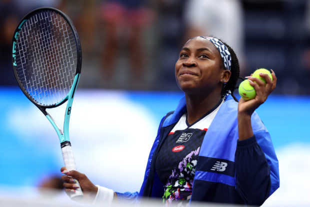 Coco Gauff of the United States smiles before hitting balls into the stands after her win against Shuai Zhang of China during their Women's Singles Fourth Round match on Day Seven of the 2022 US Open at USTA Billie Jean King National Tennis Center on September 04, 2022 in the Flushing neighborhood of the Queens borough of New York City.   Elsa/Getty Images/AFP (Photo by ELSA / GETTY IMAGES NORTH AMERICA / Getty Images via AFP)