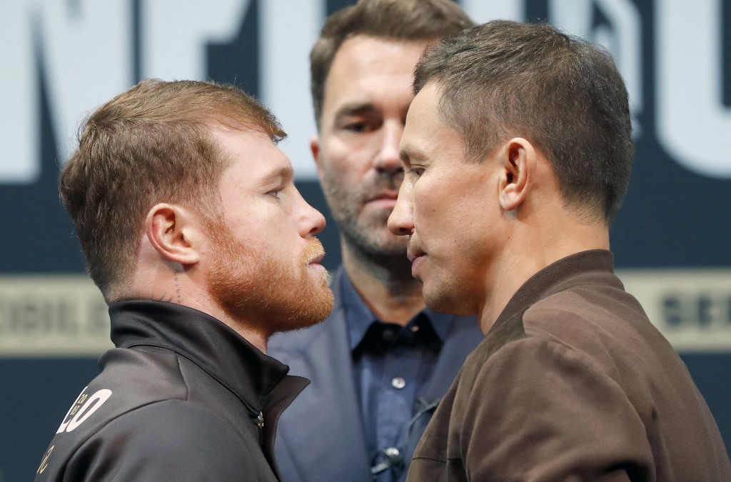 Undisputed super middleweight boxer Canelo Alvarez (L) faces off with Gennady Golovkin during a news conference at the KA Theatre at MGM Grand Hotel & Casino on September 15, 2022 in Las Vegas, Nevada. Boxing promoter Eddie Hearns is in the background at center   
