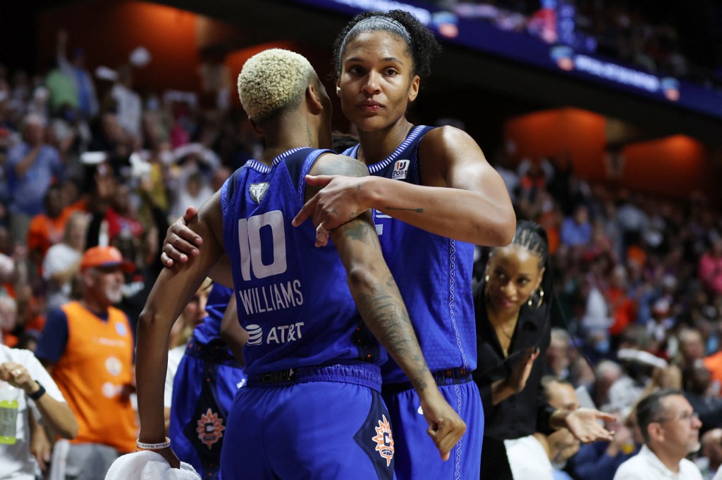 Alyssa Thomas #25 of the Connecticut Sun is congratulated by teammate Courtney Williams #10 as she is removed from the game in the fourth quarter against the Las Vegas Aces during Game Three of the 2022 WNBA Finals at Mohegan Sun Arena on September 15, 2022 in Uncasville, Connecticut. Thomas recorded the first triple-double in WNBA  