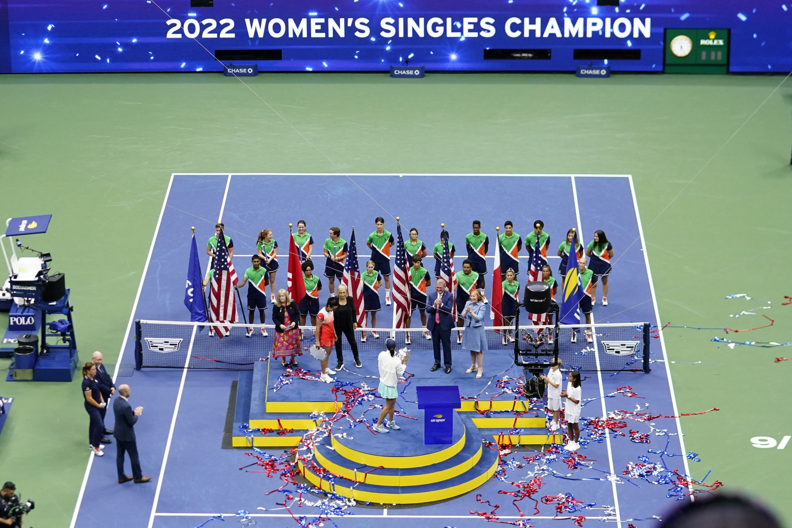 Iga Swiatek (POL) celebrates with the championship trophy after her match against Ons Jabeur (TUN) (L) in the women's singles final on day thirteen of the 2022 U.S. Open tennis tournament at USTA Billie Jean King Tennis Center. 