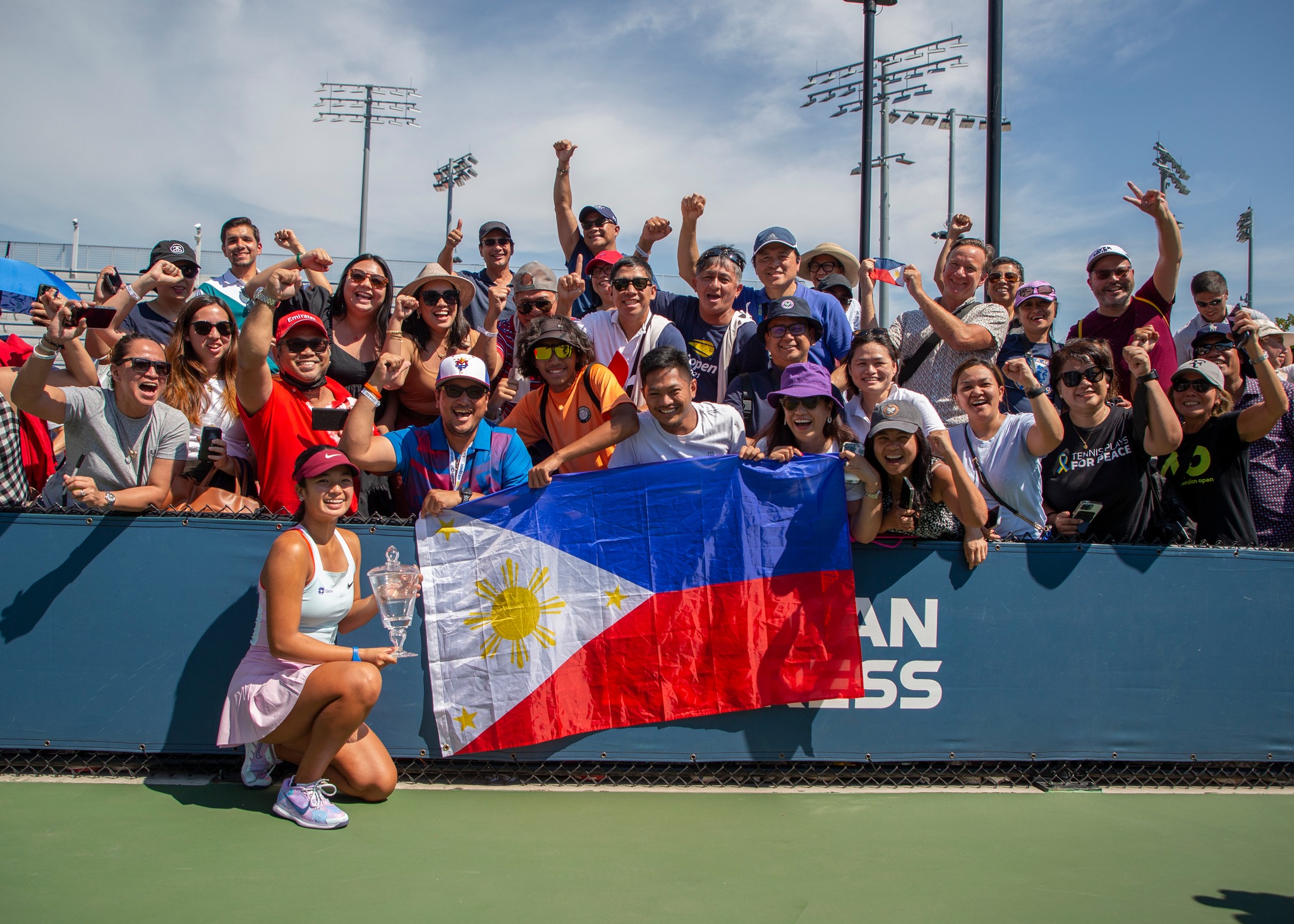 Alex Eala (photo below) always had her eyes on the prize. She then poses with her biggest support system, (from left, front row) father Mike, brother Miko and mom Rizza, together with the Philippine flag and delirious Filipino fans. —PHOTOS BY KEATS LONDON