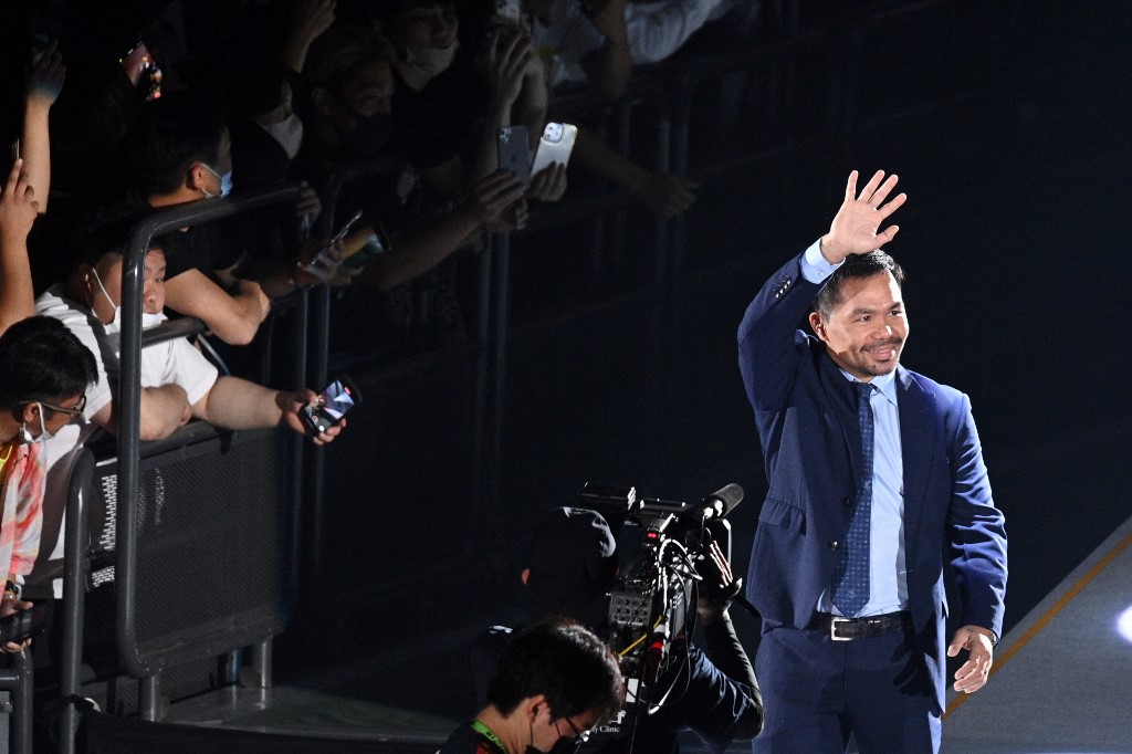 Boxing legend Manny Pacquiao of the Philippines (R) waves as he enters the arena to attend the exhibition match between US boxer Floyd Mayweather and Japanese mixed martial artist Mikuru Asakura at the Saitama Super Arena in Saitama on September 25, 2022. 
