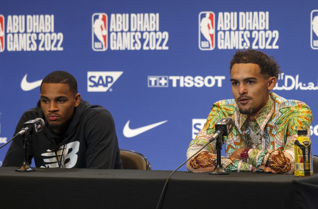 Atlanta Hawks' guard Trae Young (R) and Atlanta Hawks' guard Dejounte Murray attend a press conference after the NBA pre-season basketball match between the Milwaukee Bucks and the Atlanta Hawks at the Etihad Arena on Yas Island in Abu Dhabi, on October 6, 2022. (