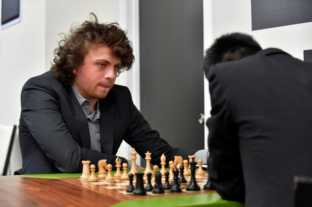 (FILES) In this file photo taken on October 6, 2022 US international grandmaster Hans Niemann waits his turn to move during a second-round chess game against Jeffery Xiong on the second day of the Saint Louis Chess Club Fall Chess Classic in St. Louis, Missouri. -