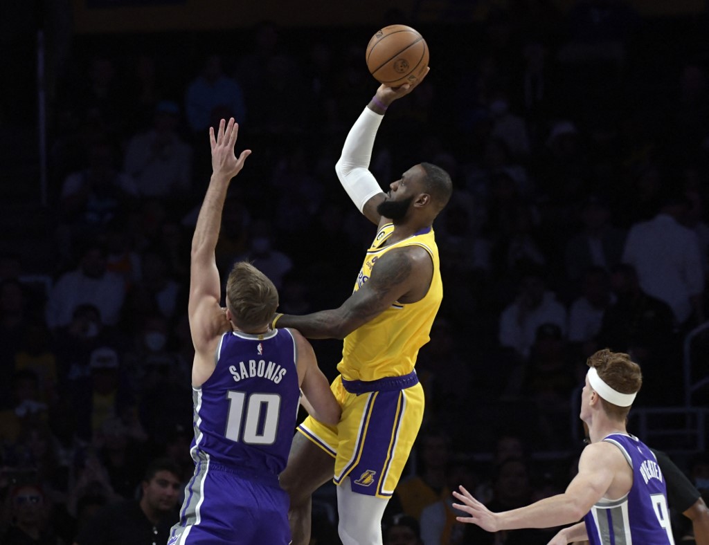  LeBron James #6 of the Los Angeles Lakers shoots over Domantas Sabonis #10 of the Sacramento Kings and Kevin Huerter looks on during the first half of a preseason game at Crypto.com Arena on October 3, 2022 in Los Angeles, California.   