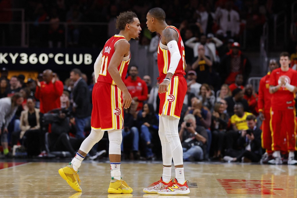 Trae Young #11 and Dejounte Murray #5 of the Atlanta Hawks react during the second half against the Houston Rockets at State Farm Arena on October 19, 2022 in Atlanta, Georgia. 