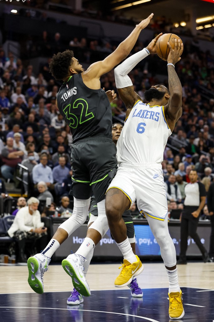 LeBron James #6 of the Los Angeles Lakers is fouled by Karl-Anthony Towns #32 of the Minnesota Timberwolves in the fourth quarter of the game at Target Center on October 28, 2022 in Minneapolis, Minnesota.