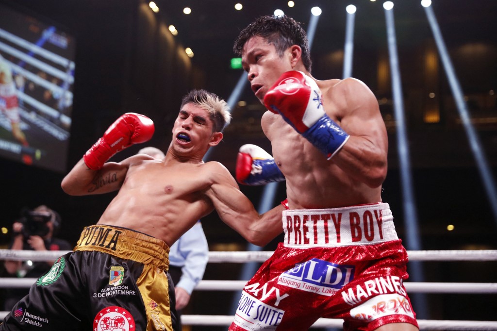 Fernando Martinez (L) lands a body shot on IBF super flyweight champion Jerwin Ancajas during a title fight at The Chelsea at The Cosmopolitan of Las Vegas on February 26, 2022 in Las Vegas, Nevada. Martinez took the title by unanimous decision.