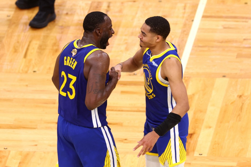 FILE-Jordan Poole #3 and Draymond Green #23 of the Golden State Warriors celebrate against the Boston Celtics during the 4th round of Game 6 of the 2022 NBA Finals at TD Garden on June 16, 2022 in Boston, Massachusetts.