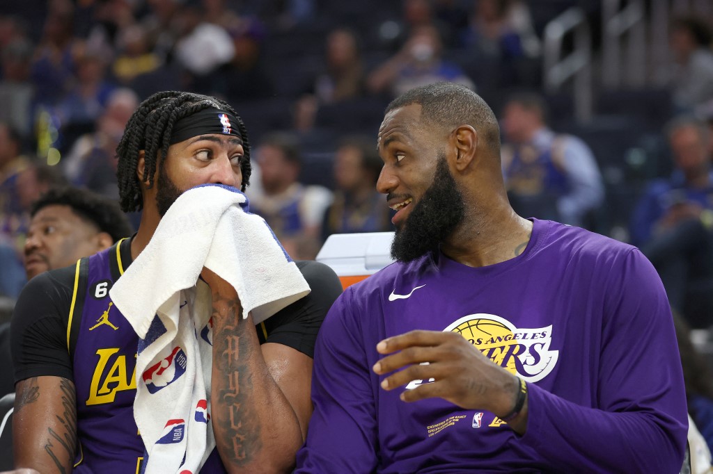 Anthony Davis #3 talks to LeBron James #6 of the Los Angeles Lakers on the bench during their game against the Golden State Warriors at Chase Center on October 18, 2022 in San Francisco, California.
