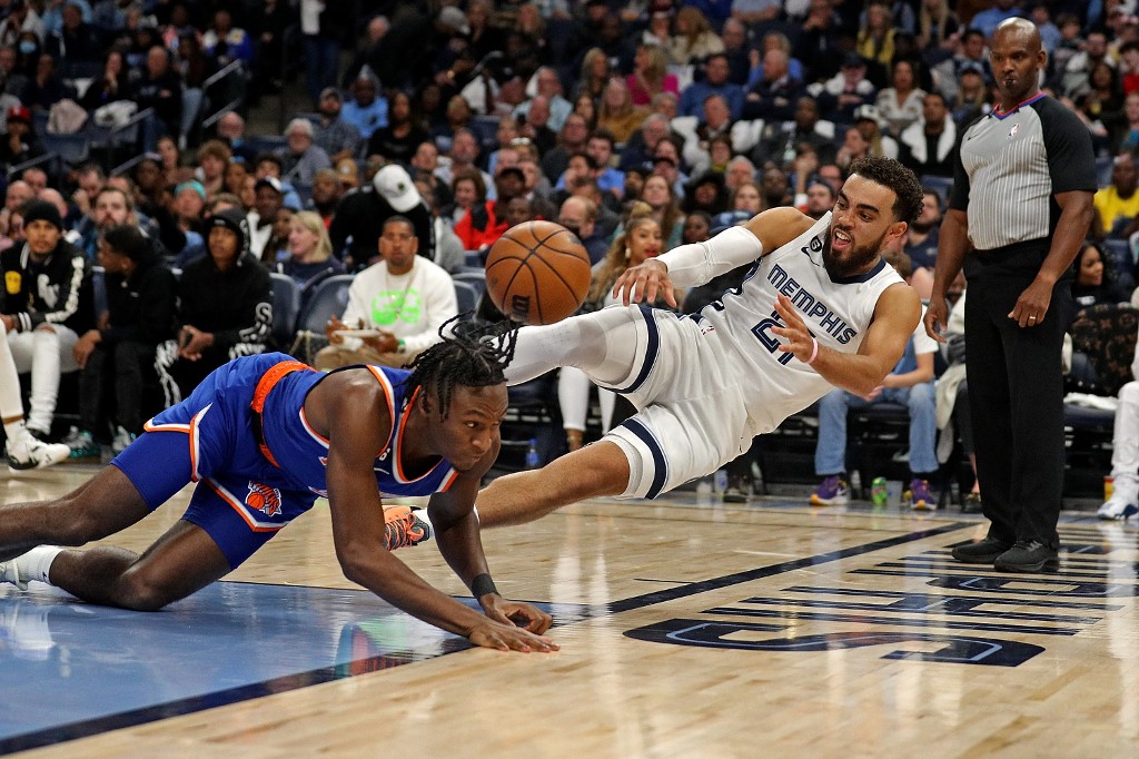 Tyus Jones #21 of the Memphis Grizzlies throws the basketball at Immanuel Quickley #5 of the New York Knicks during the game at FedExForum on October 19, 2022 in Memphis, Tennessee. 