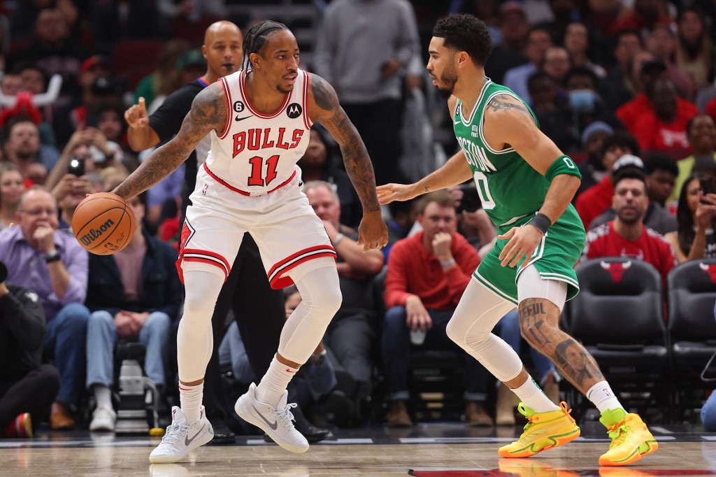DeMar DeRozan #11 of the Chicago Bulls dribbles Jayson Tatum #0 of the Boston Celtics during the first half at United Center on October 24, 2022 in Chicago, Illinois.