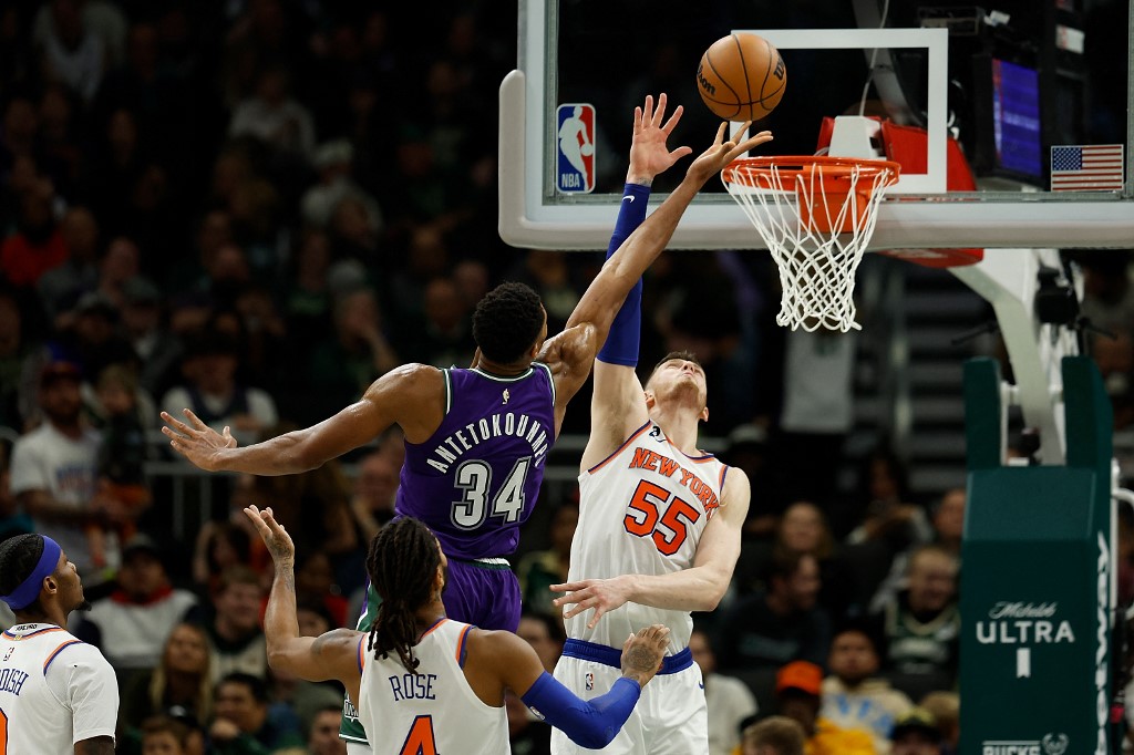 Giannis Antetokounmpo #34 of the Milwaukee Bucks scores over the reach of Isaiah Hartenstein #55 of the New York Knicks during the second half of a game at Fiserv Forum on October 28, 2022 in Milwaukee, Wisconsin. 