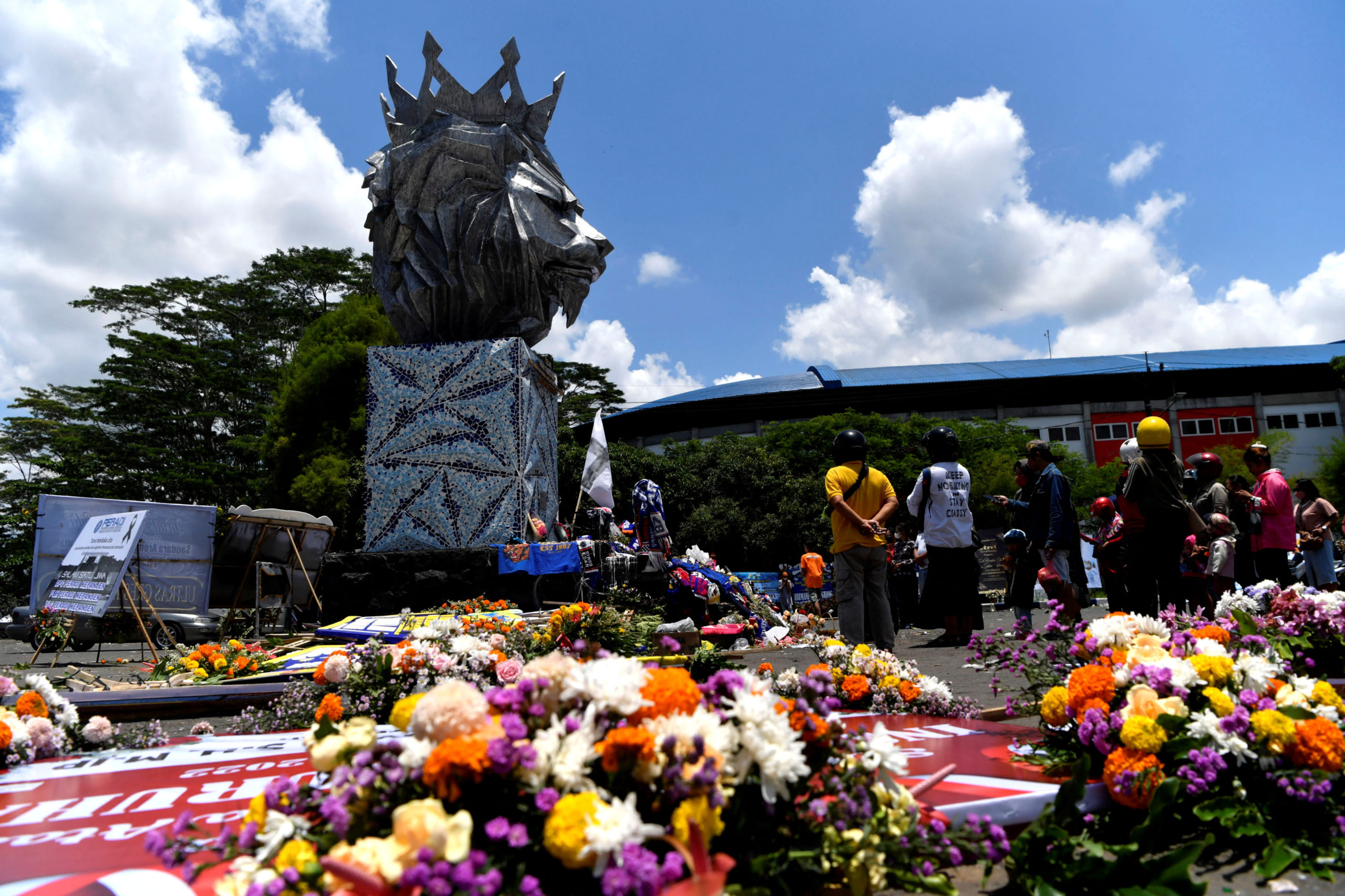 FILE PHOTO: People gather at the Lion Statue of Kanjuruhan Stadium as they pay their condolences for the victims of a riot and stampede following a soccer match between Arema vs Persebaya Surabaya in Malang, East Java province, Indonesia, October 4, 2022, in this photo taken by Antara Foto.