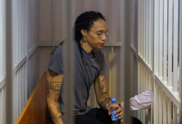 FILE PHOTO: U.S. basketball player Brittney Griner, who was detained at Moscow's Sheremetyevo airport and later charged with illegal possession of cannabis, sits inside a defendants' cage after the court's verdict in Khimki outside Moscow, Russia August 4, 2022.