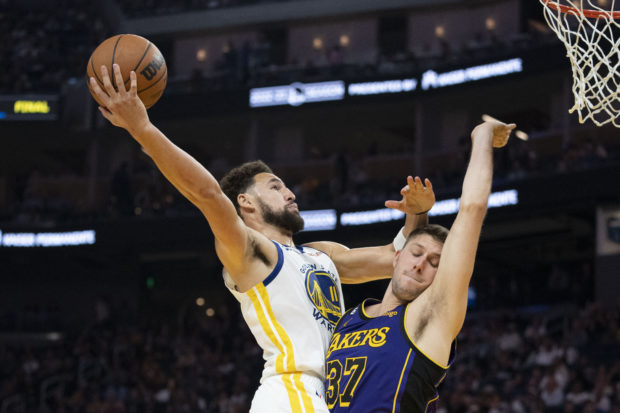  October 18, 2022; San Francisco, California, USA; Golden State Warriors guard Klay Thompson (11) shoots the basketball against Los Angeles Lakers forward Matt Ryan (37) during the second quarter at Chase Center. Kyle Terada-USA TODAY Sports