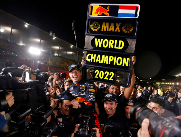 FILE PHOTO: Formula One F1 - Japanese Grand Prix - Suzuka Circuit, Suzuka, Japan - October 9, 2022 Red Bull's Max Verstappen celebrates winning the race and the championship with his team