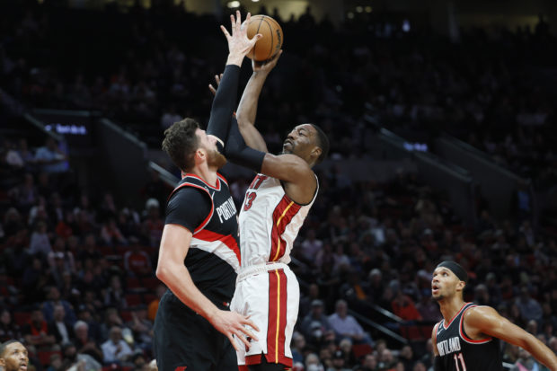 Miami Heat center Bam Adebayo (13) puts up a shot over Portland Trail Blazers center Jusuf Turkic (27) during the second half at Moda Center.