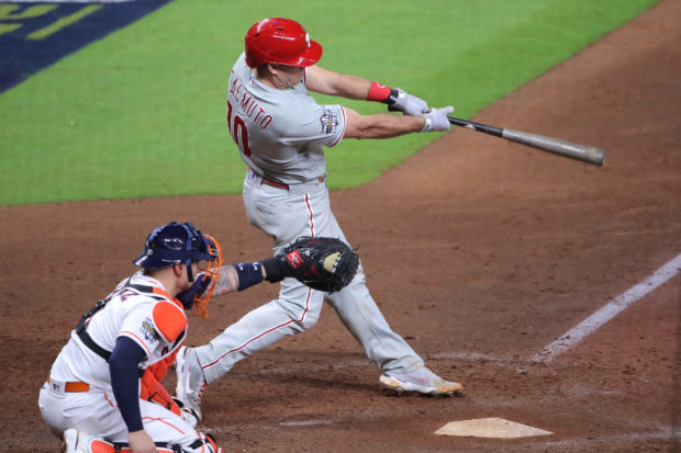 Oct 28, 2022; Houston, Texas, USA; Philadelphia Phillies catcher J.T. Realmuto (10) hits a home run during the tenth inning against the Houston Astros in game one of the 2022 World Series at Minute Maid Park.