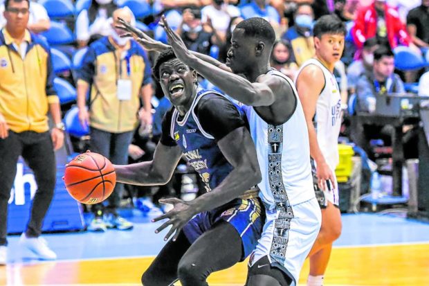 Malik Diouf (right) typifies the unforgiving defense the Maroons threw on Omar John and the Bulldogs. —UAAP PHOTO