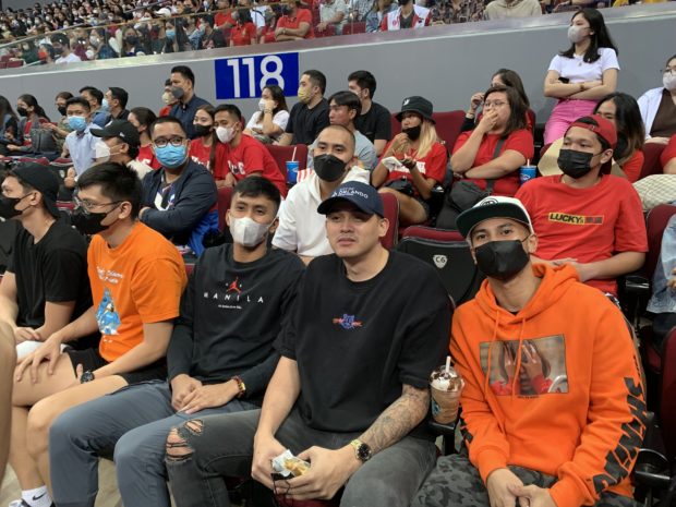 Former UE players Paul Lee, Roi Sumang, and Rey Suerte watching a UAAP game. 