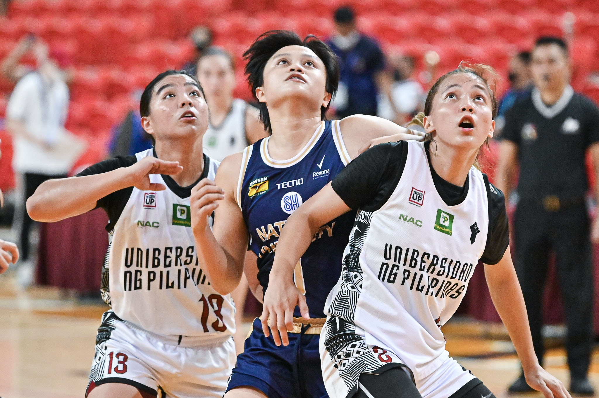 NU's Mikka Cacho vs two UP defenders