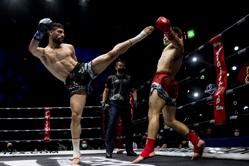 In this photo taken on September 24, 2022, Muay Thai boxers Ali Asghar from Iran and Federico Vernengo (R) from Argentina compete during their fight at Lumpinee Stadium in Bangkok. - The ancient combat sport of Muay Thai has set its sights on Olympic glory, but a recent death has highlighted safety concerns that could slow its path to a Games debut. 