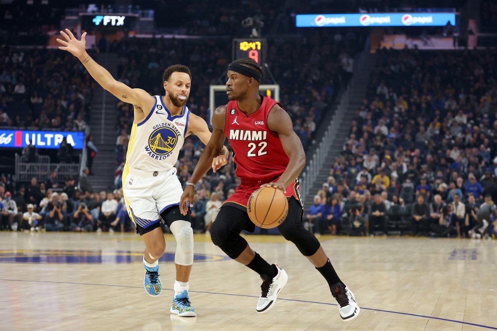 FILE– Jimmy Butler #22 of the Miami Heat is guarded by Stephen Curry #30 of the Golden State Warriors at Chase Center on October 27, 2022 in San Francisco, California