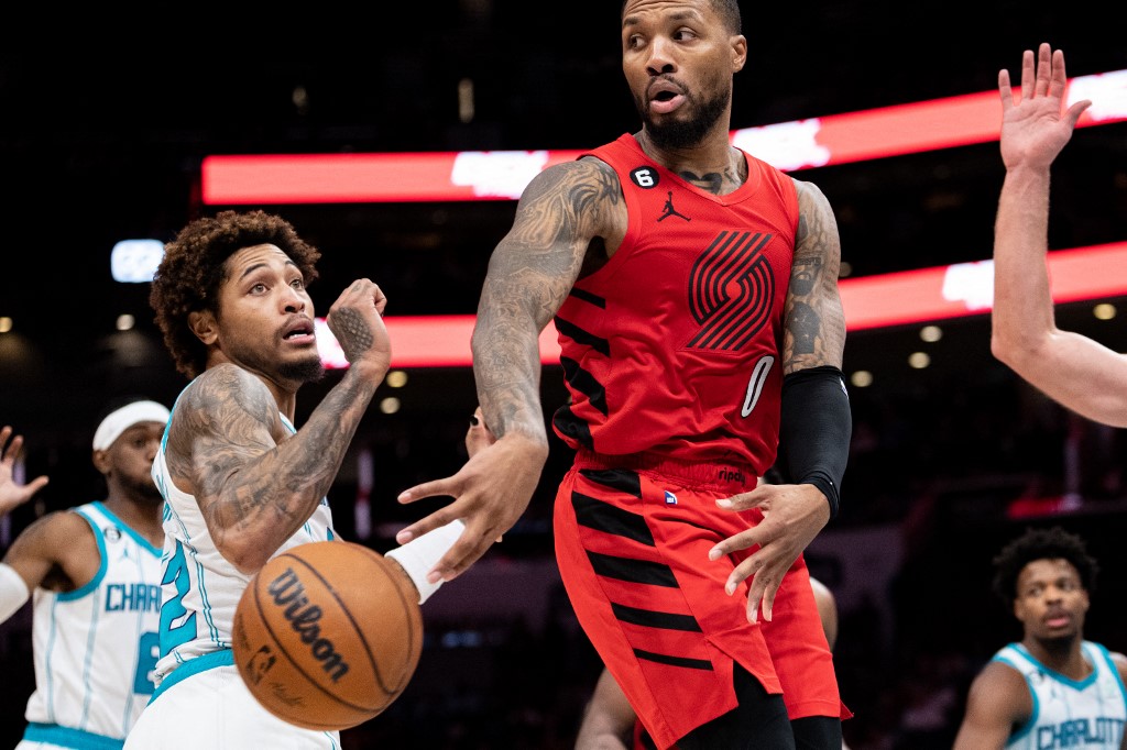 Damian Lillard #0 of the Portland Trail Blazers passes the ball against Kelly Oubre Jr. #12 of the Charlotte Hornets in the third quarter at Spectrum Center on November 09, 2022 in Charlotte, North Carolina. 