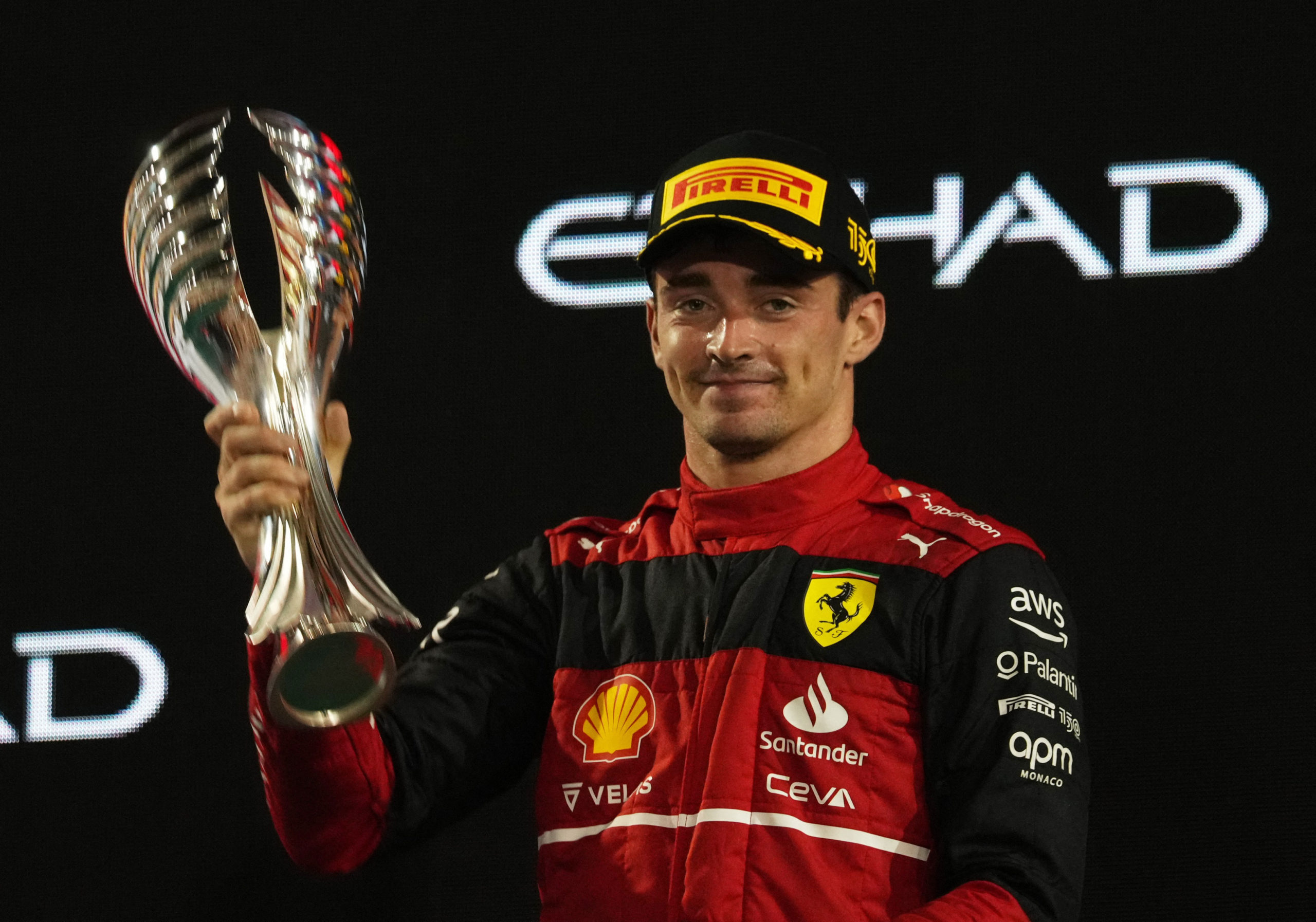 d Prix - Yas Marina Circuit, Abu Dhabi, United Arab Emirates - November 20, 2022 Ferrari's Charles Leclerc celebrates with a trophy on the podium after finishing in second place in the Abu Dhabi Grand Prix 