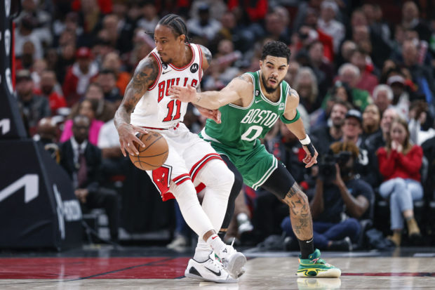Nov 21, 2022; Chicago, Illinois, USA; Chicago Bulls forward DeMar DeRozan (11) is defended by Boston Celtics forward Jayson Tatum (0) during the second half at United Center. 