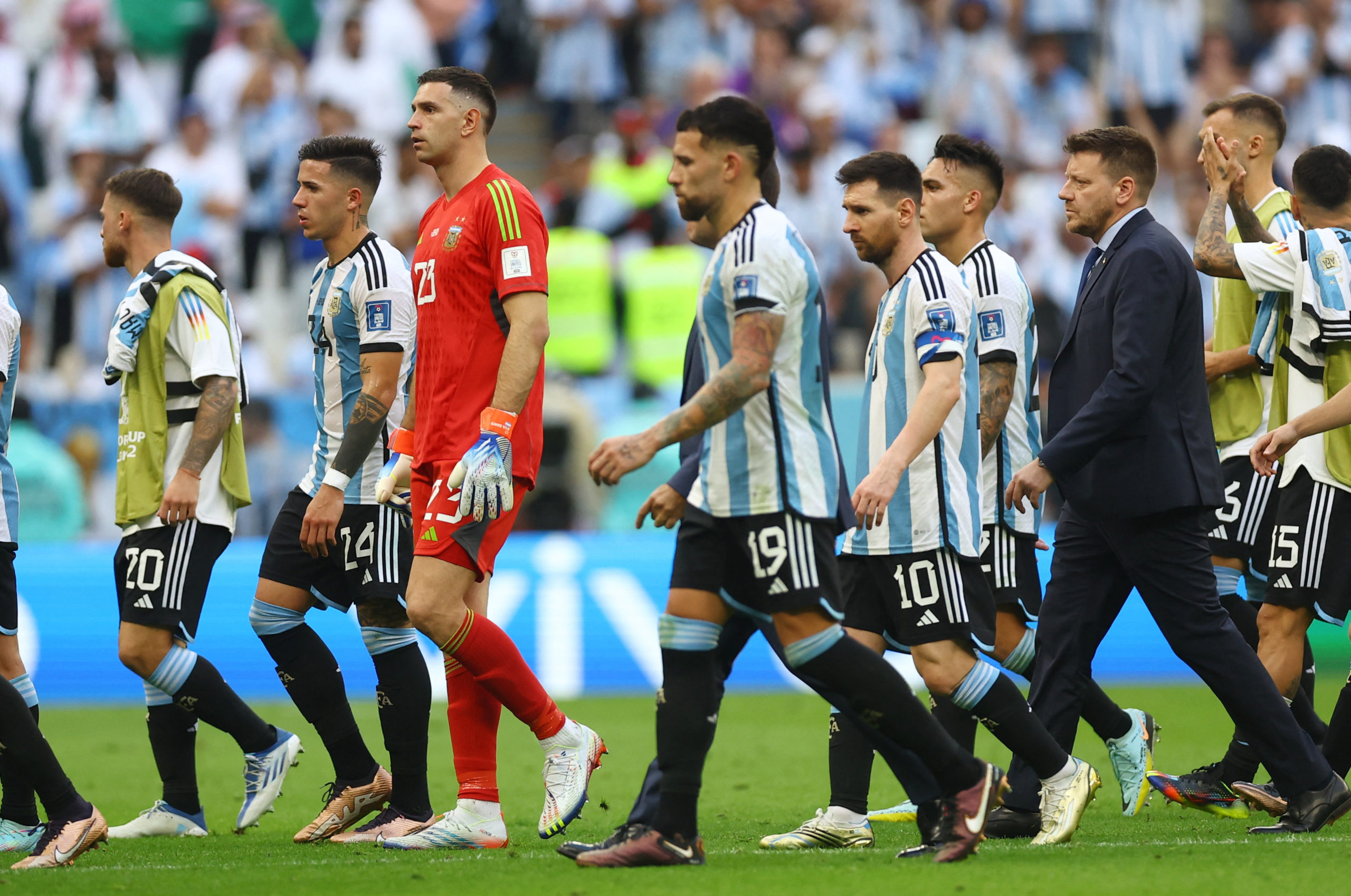 Soccer Football - FIFA World Cup Qatar 2022 - Group C - Argentina v Saudi Arabia - Lusail Stadium, Lusail, Qatar - November 22, 2022 Argentina's Lionel Messi and teammates look dejected after the match 