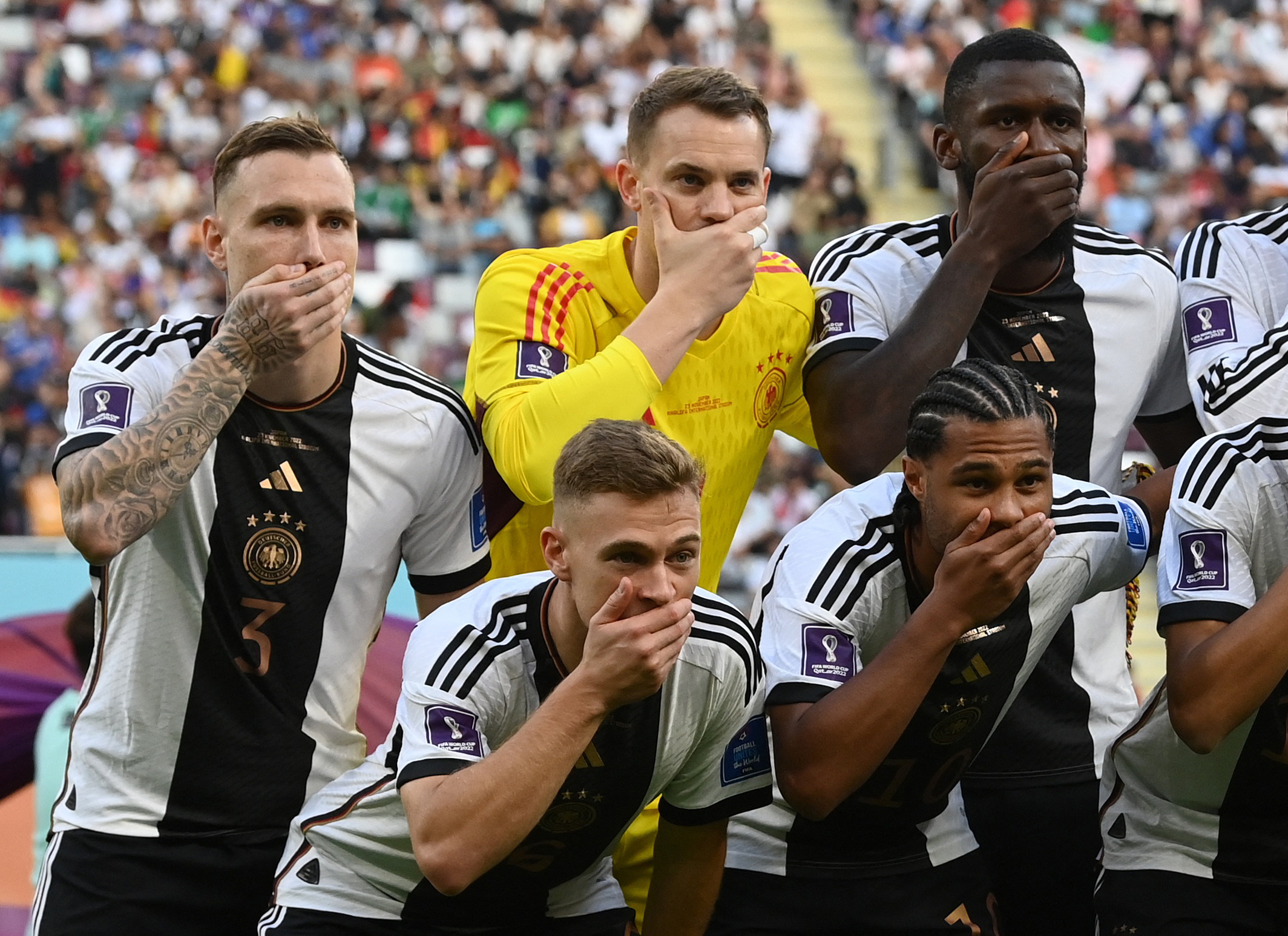 Soccer Football - FIFA World Cup Qatar 2022 - Group E - Germany v Japan - Khalifa International Stadium, Doha, Qatar - November 23, 2022 Germany players cover their mouths as they pose for a team group photo before the match 