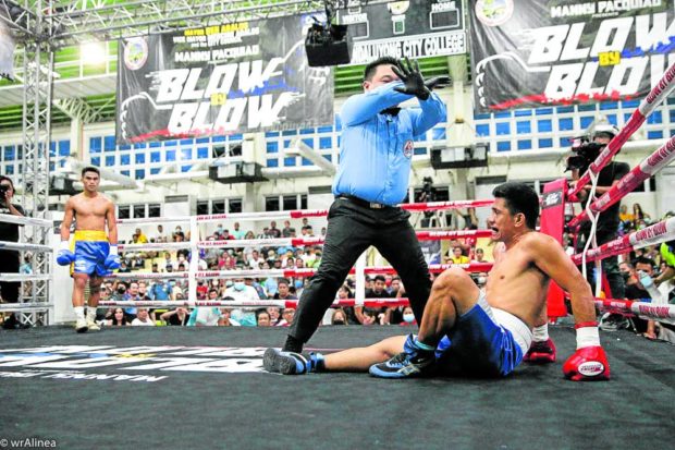 Pitt Laurente (left) watches as referee Danrex Tapdasan counts out JR Magboo. —PHOTO COURTESY OF BLOW BY BLOW
