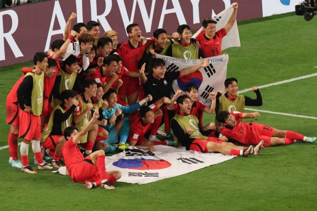 South Korea's players celebrate qualifying for the World Cup last 16 at Uruguay's expense during the Qatar 2022 World Cup Group H football match between South Korea and Portugal at the Education City Stadium in Al-Rayyan, west of Doha on December 2, 2022.