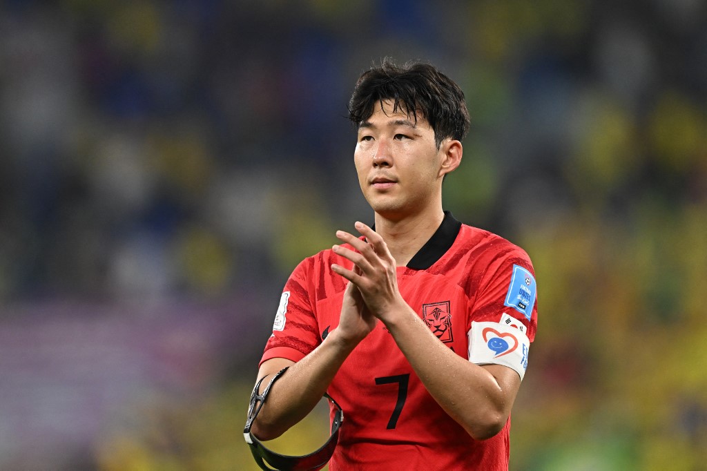 s midfielder #07 Son Heung-min applauds supporters after his team lost the Qatar 2022 World Cup round of 16 football match between Brazil and South Korea at Stadium 974 in Doha on December 5, 2022.