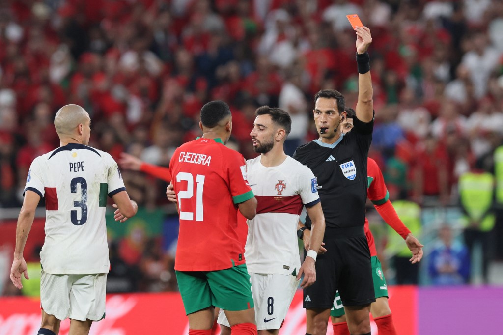 Morocco's midfielder #21 Walid Cheddira (2ndL) receives a red card from Argentinian referee Facundo Tello during the Qatar 2022 World Cup quarter-final football match between Morocco and Portugal at the Al-Thumama Stadium in Doha on December 10, 2022. 