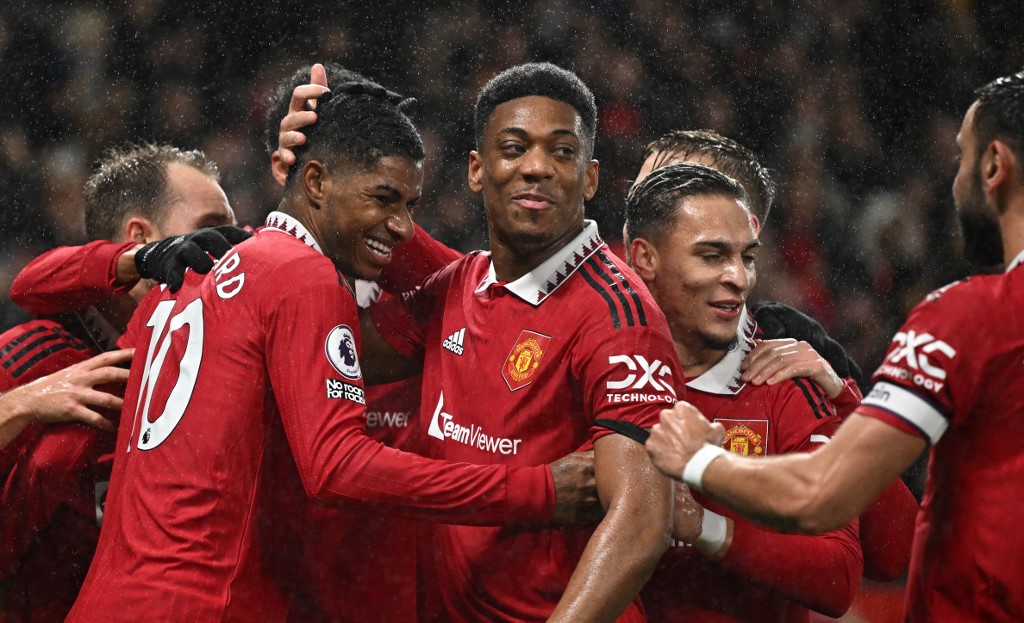 Manchester United England striker Marcus Rashford (left) celebrates with teammates after scoring his team's first goal during the English Premier League football match between Manchester United and Nottingham Forest at Old Trafford in Manchester, northwest England, on December 27, 2022. 