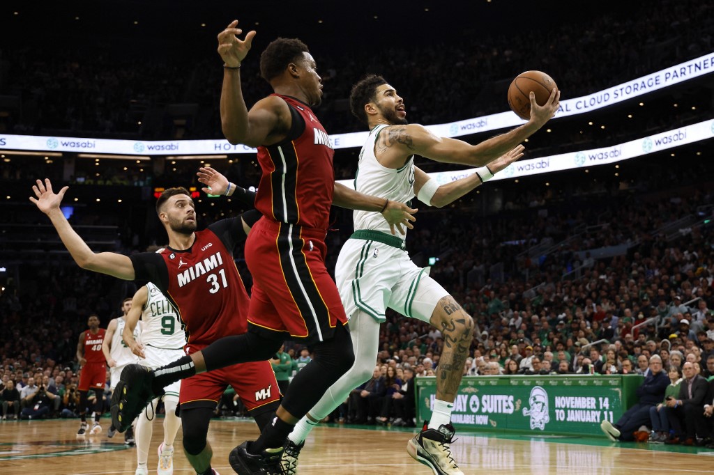 Jayson Tatum #0 of the Boston Celtics goes to the basket past Max Strus #31 of the Miami Heat and Kyle Lowry during the second half at TD Garden on November 30, 2022 in Boston, Massachusetts. 