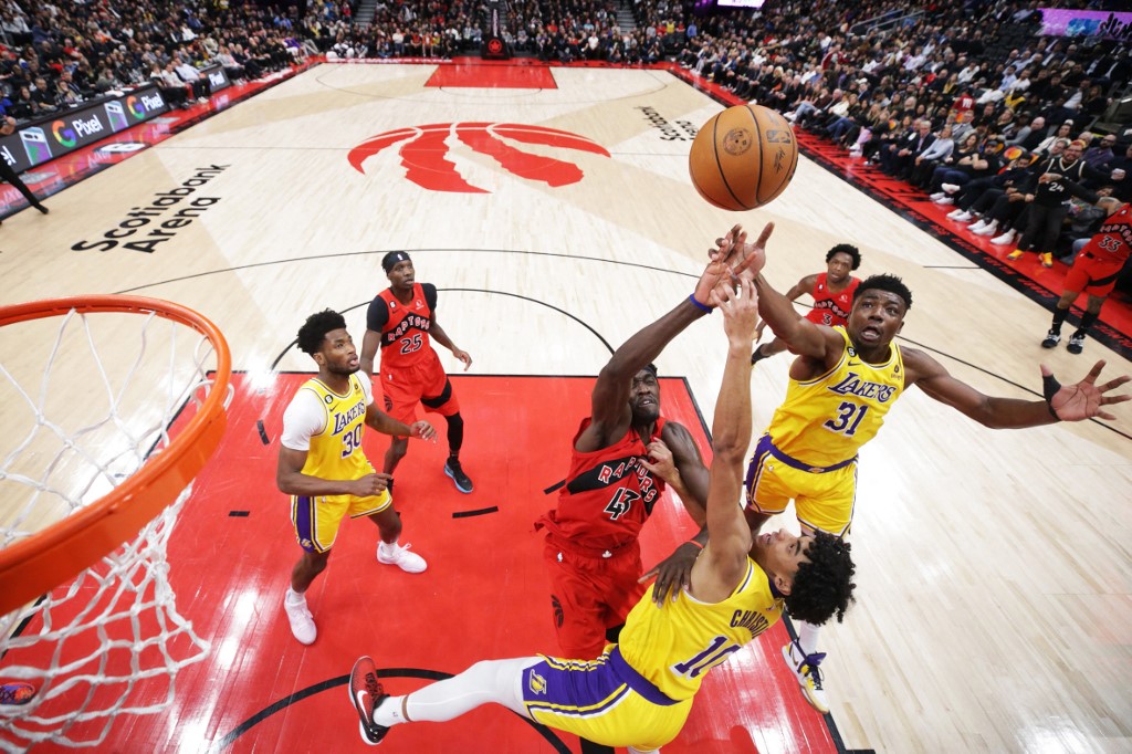 Thomas Bryant #31 and Max Christie #10 of the Los Angeles Lakers vs Pascal Siakam #43 of the Toronto Raptors for a loose ball during the second half of their NBA game at Scotiabank Arena on December 7, 2022 in Toronto, Canada
