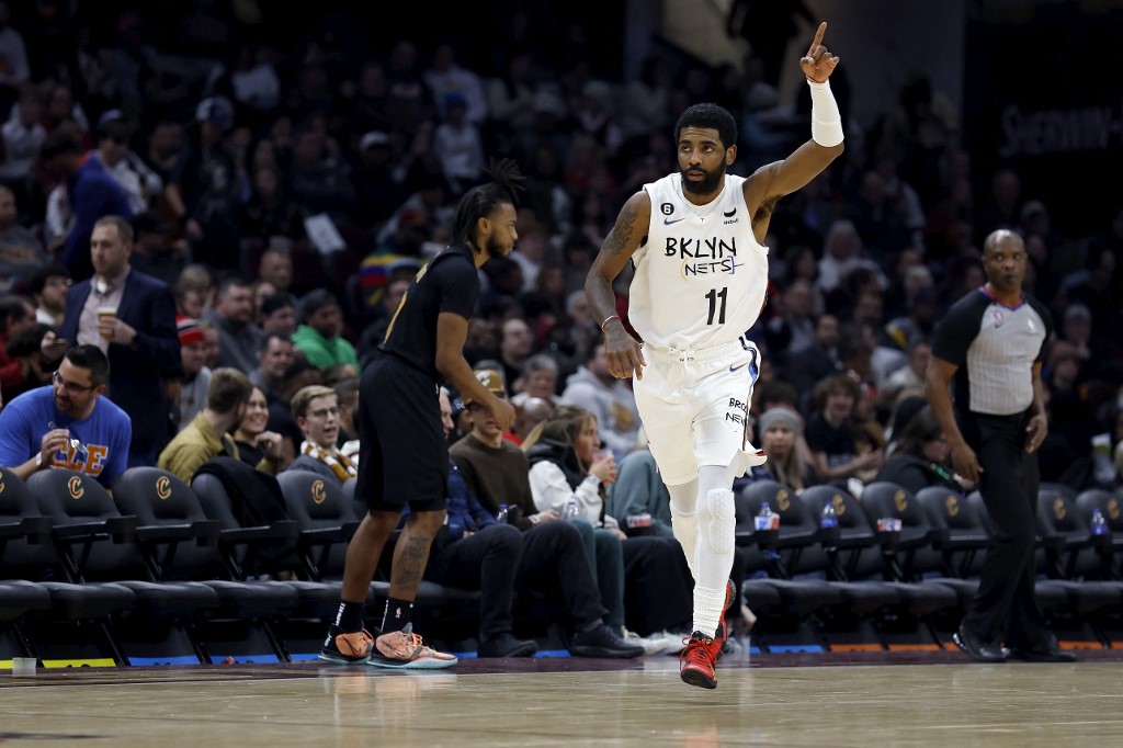 Kyrie Irving #11 of the Brooklyn Nets reacts after making a three-point shot during the third quarter of the game against the Cleveland Cavaliers at Rocket Mortgage Fieldhouse on December 26, 2022 in Cleveland, Ohio. 