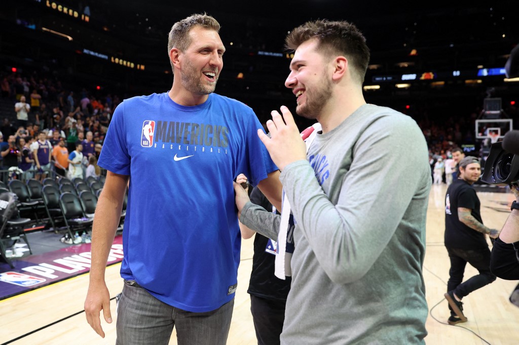  Former Dallas Mavericks player Dirk Nowitzki talks with Luka Doncic #77 of the Dallas Mavericks after the Mavericks defeated the Suns 123-90 in Game Seven of the 2022 NBA Playoffs Western Conference Semifinals at Footprint Center on May 15, 2022 in Phoenix, Arizona. 