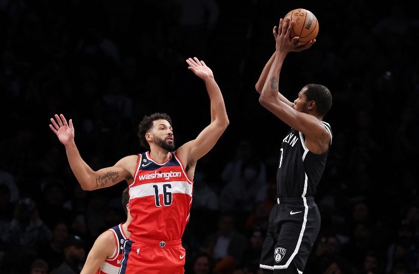 Kevin Durant #7 of the Brooklyn Nets shoots against Anthony Gill #16 of the Washington Wizards during their game at Barclays Center on November 30, 2022 in New York City.