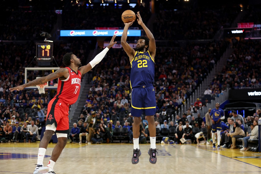 Andrew Wiggins #22 of the Golden State Warriors shoots over Tari Eason #17 of the Houston Rockets at Chase Center on December 03, 2022 in San Francisco, California